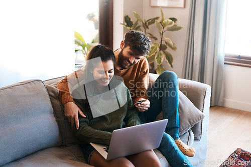 Image of Laptop, credit card and happy couple on sofa, online shopping or cashback and spending in home. Smile, man and woman on couch to relax together, ecommerce or payment with bonding time and happiness.