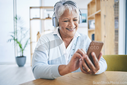 Image of Senior woman, phone and music headphones with a smile while listening to audio, radio or podcast. Elderly female person in a house with a smartphone for streaming online, mobile app and relax