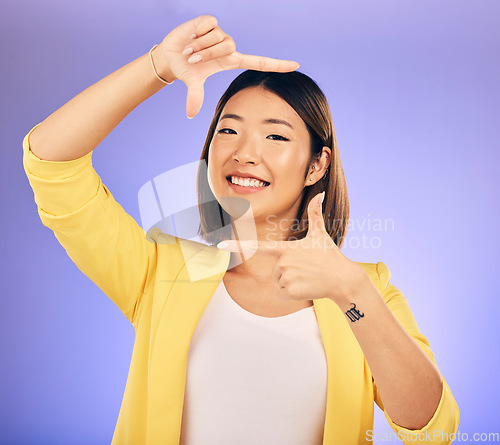 Image of Portrait, frame and Asian woman with a smile, fashion and emoji against a studio background. Face, female person and model with hand gesture, beauty and creative with happiness and finger framing