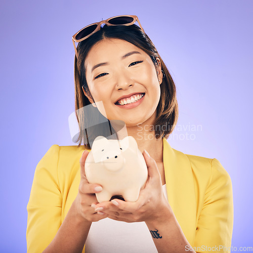 Image of Piggy bank, saving and portrait of Asian woman in studio for investment, financial profit and budget. Finance, banking and face of happy female person with money container for savings, cash and coins