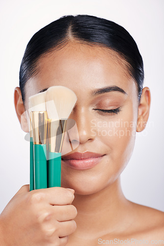 Image of Brush for makeup, face and beauty with woman, foundation and powder isolated on studio background. Closeup of female model, natural cosmetics and skin glow with cosmetic tools and cosmetology