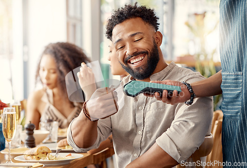 Image of Ecommerce, credit card and man in a restaurant, machine and online payment with happiness, retail and social gathering. Male person, group and customer in a cafe, service and transaction for lunch