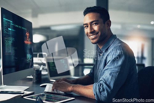 Image of Portrait, man and smile of programmer on computer in office workplace at night. IT, face and male coder or person programming, coding and writing for software development or information technology.