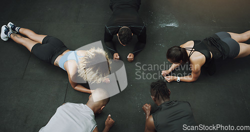 Image of Top view, fitness and people do push up in circle in gym for training, exercise and workout class. Teamwork, body builder and men and women in sports club for challenge, wellness or strength on floor