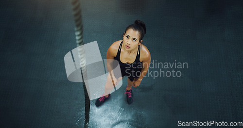 Image of Rope climbing, woman and fitness at gym from above for training, performance and intense cardio on black background. Top view, climb and female with ropes, resilience and mindset during power workout