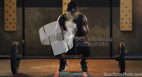 Image of Weightlifting, powder and black man with barbell in gym for training, exercise and serious workout. Sports, strong muscle and male body builder lifting weights for challenge, wellness and strength