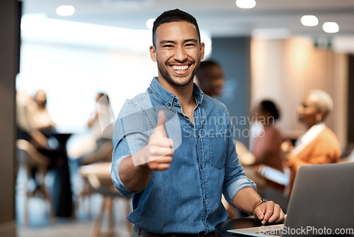 Image of Portrait, business and man with a laptop, thumbs up and internet connection in a modern office, smile and agreement. Face, male person and employee with a pc, technology and professional with support