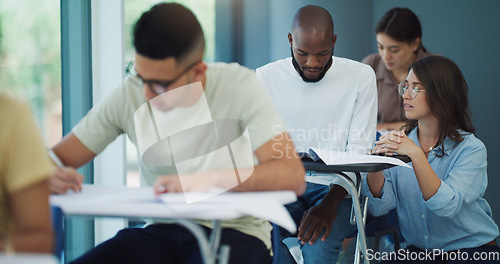 Image of Exam, professor helping a student and knowledge with education, university and studying. Female person, employee and teacher in a classroom, advice and tips for test, assignment and discussion