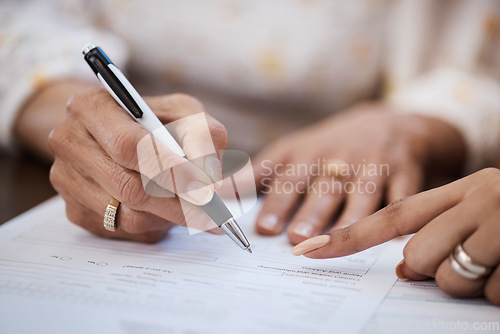 Image of Hands, pen and closeup of a woman signing a document, contract or application with an advisor. Zoom of a female person with a signature for paperwork, form or agreement with a professional lawyer.