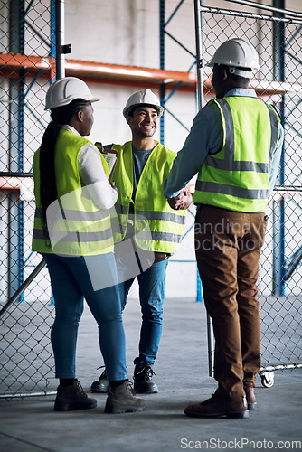 Image of Builder, team and handshake at a construction site for a collaboration and partnership. Professional, contractor.and greeting at a warehouse for a job and project with a contract at a company.