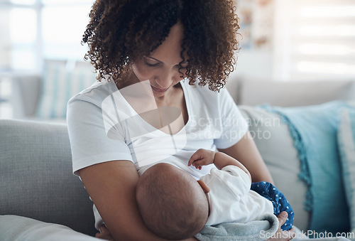 Image of Love, living room and mother breastfeeding her baby for health, nutrition and wellness at home. Bonding, care and young woman nursing or feeding her newborn child milk on the sofa in the family house