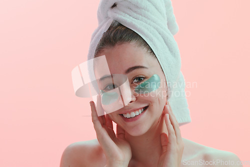 Image of Portrait, skincare and woman with eye mask happy in studio for beauty, collagen and anti aging on pink background. Face, patches and female model with skin cosmetics, facial and hydration treatment