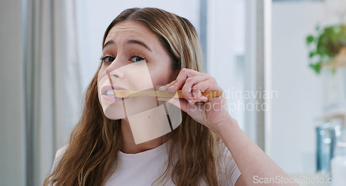 Image of Portrait, toothbrush and girl in bathroom for cleaning, hygiene and oral care in her home. Brushing teeth, face and female person in apartment for morning, routine or fresh, breath or mouth treatment