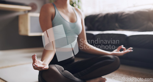 Image of Yoga, lotus and hands of woman on living room floor for breath, exercise or zen in her home. Inner peace, meditation and female person relax while meditating for healing, balance or wellness training