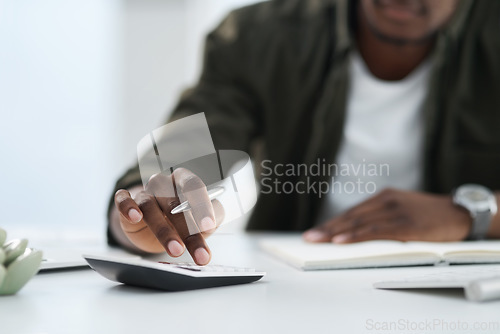 Image of Hand, accountant with calculator and notebook planning at his desk at work. Finance or budget strategy, income and male entrepreneur or businessman working with money in office at his workplace