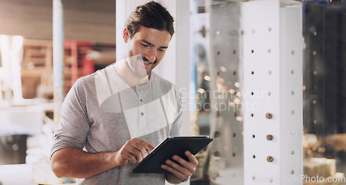 Image of Tablet, industry and planning with a man in a factory for manufacturing, production or metal work. Logistics, construction and technology with an industrial engineer working in a workshop or plant