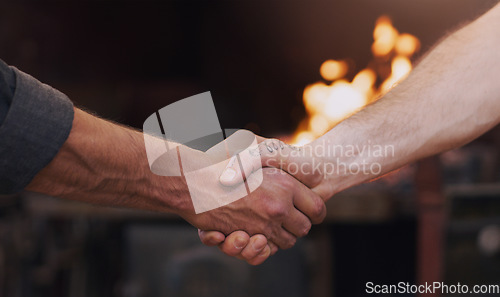 Image of Handshake, meeting and thank you with men in a workshop together for a deal or agreement. Teamwork, welcome and partnership with male industry people shaking hands in a factory to gesture a greeting