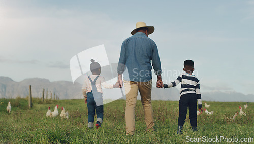 Image of Family, holding hands and a dad walking on a farm with his children for agriculture or sustainability. Back, farming an a father with his kids in the meadow as a cow farmer in the natural countryside