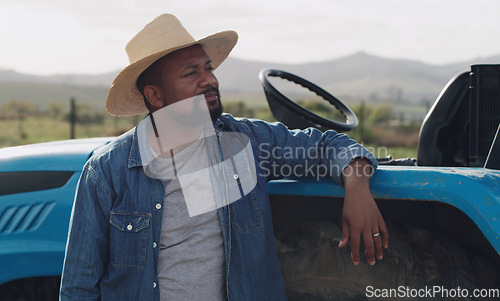 Image of Farming, vision and a black man with a tractor on a farm for agriculture growth and sustainability. Idea, planning and an African farmer in the countryside with ideas for sustainable business