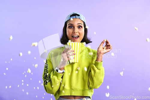 Image of Surprise, wow and woman with popcorn for a movie or streaming service or cinema and in studio against a purple background. Video, entertainment and film or television or omg and snack on mock up