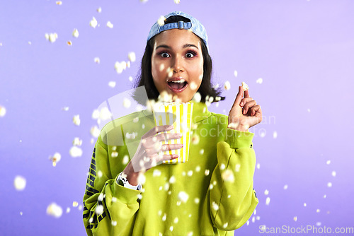 Image of Popcorn, movie and woman surprise watching theatre or streaming service or cinema and in studio against a purple background. Video, entertainment and film or television or omg and snack on mock up