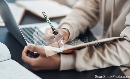 Image of Closeup, hands and man writing in a notebook, remote work from home and planning with schedule, laptop or connection. Male person, freelancer or entrepreneur with a diary, journal or creative project