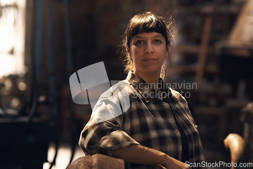 Image of Woman blacksmith, portrait and workshop for industry, trade or artisan job for entrepreneurship. Small business owner, female entrepreneur or confident in factory, industrial warehouse or metalwork