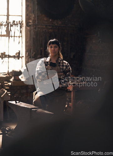 Image of Blacksmith, workshop and portrait of woman with tools for industry, manufacturing and machinery. Industrial factory, welding and female person for steel, iron and metal production for craftsmanship