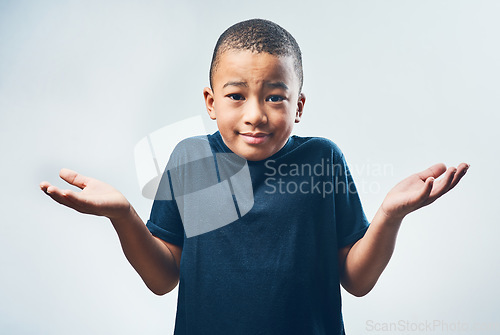 Image of Shrugging, doubt and portrait of a child with a decision isolated on a white background in a studio. Confused, young and a little boy with a gesture for choice, indecision and confusion or uncertain