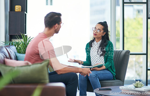 Image of Mental health, therapy or counseling with a woman psychologist and male patient talking in her office. Psychology, wellness and trust with a female doctor or shrink consulting a man for healing