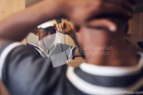 Image of Baseball player, cap and face of sports man in a locker room getting ready and dressing in mirror. Behind an African athlete person with reflection and hat for sport competition, training or exercise