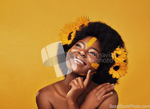 Image of Thinking, beauty and happy black woman with sunflower in studio for makeup or wellness on yellow background. Flower, skincare and African lady model smile, relax or contemplate eco friendly treatment