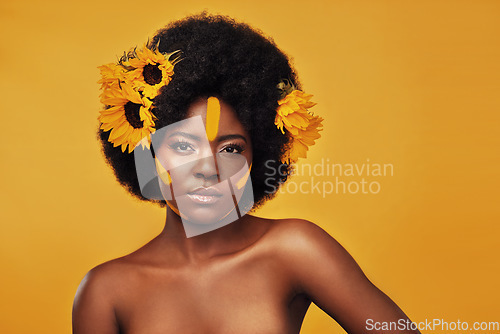 Image of Makeup, sunflower and paint with portrait of black woman in studio for beauty, creative or spring. Natural, cosmetics and floral with face of model on yellow background for art, self love or glow