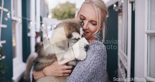 Image of Dogs, trust and a woman carrying her pet in the home as a companion for love, safety or friendship. Happy, dog and a female animal owner holding her purebred husky puppy over her shoulder in a house