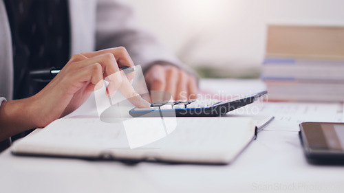 Image of Calculator, accounting and hands of a woman writing in notebook for business budget, investment or planning. Accountant person with pen for tax list on profit, financial goals or income on a desk