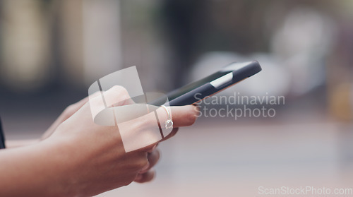 Image of Woman, hands and searching phone with city background for texting message on social media. Female hand, typing and cellphone for research or writing messages for communication and connection.