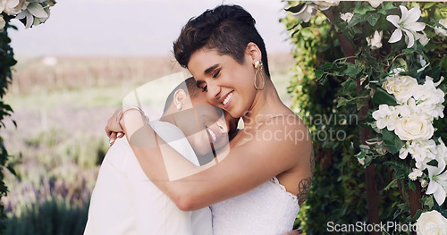 Image of Love, hug and lgbtq with lesbian couple at wedding for celebration, gay and pride. Smile, spring and happiness with women at marriage event for partner commitment, sexuality and freedom