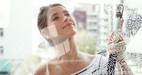 Image of Woman, clean house window with foam and detergent, chemical liquid and housekeeping with smile. Female cleaner with soap, cleaning glass and disinfectant with hygiene, housekeeper and maintenance