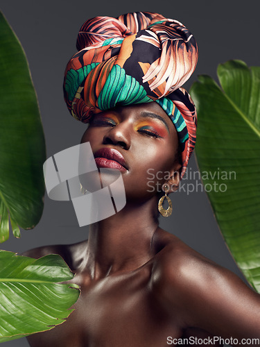 Image of Beauty, leaf and makeup by black woman in studio for self love or natural cosmetics on grey background. Culture, monstera and face of African lady model with plant for dermatology or jungle aesthetic