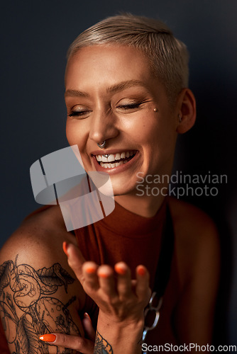 Image of Young woman, happy laugh and tattoo with hipster and gen z fashion with a smile and piercing. Cool style, face and cosmetics of a female person with happiness, confidence and jewelry wearing makeup