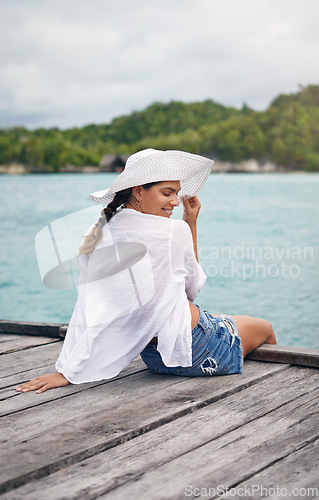 Image of Island, travel and woman relax on deck for holiday, summer vacation and weekend getaway in Maldives. Traveling, tropical ocean and female person on luxury resort for tourism, happiness and freedom