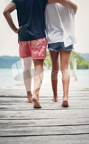 Image of Couple, relax walking and beach deck on holiday with freedom and love in summer in Thailand. Tropical nature, sea and back of people on a boardwalk walk in the sun on vacation break by ocean water