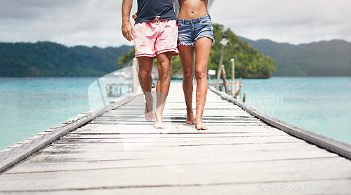 Image of Travel couple, walking and beach deck on holiday with freedom and love in summer in Thailand. Tropical nature, sea and legs of people on a boardwalk walk in the sun on vacation break by ocean water