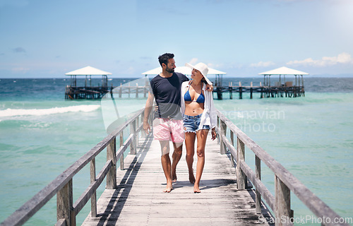 Image of Couple smile, walking and travel on a tropical island on vacation with freedom by sea. Ocean, beach and deck walk of a man back and woman together with love in summer on a holiday outdoor in sun