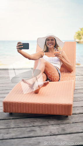 Image of Woman, lounge selfie and cocktail on tropical holiday by the ocean on deck chair with a smile. Female person, travel and Maldives island in summer taking a photo for profile picture and social media