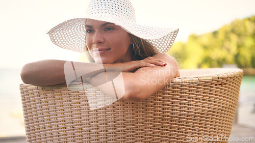 Image of Summer, fashion and woman on chair with hat for holiday, vacation and weekend outdoors. Traveling, tropical resort and female person with smile for luxury tourism, sunshine and happy at poolside