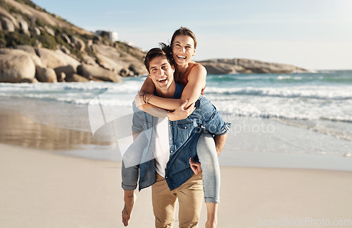 Image of Couple, portrait and piggyback with smile at beach in summer sunshine for love, romance and bond for travel. Man, woman and happy with hug, ocean waves and trust in nature, outdoor and sea holiday