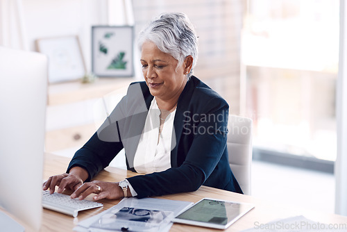 Image of Busy, computer and management with a business woman or CEO working in her corporate office. Mission, professional and leadership with a senior female manager at work typing an email or proposal