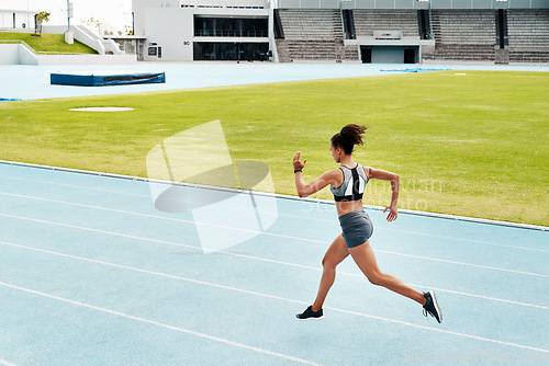 Image of Woman, fitness and running of athlete on track for exercise, cardio training or workout outdoors. Fit, active or sport female person or runner in sports run, race or athletics for wellness on stadium