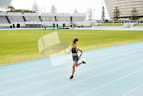 Image of Woman, fitness and running on stadium track for exercise, cardio training or workout outdoors. Fit, active or sporty female person athlete or runner in sports run, athletics or healthy wellness